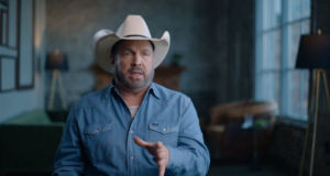 Garth Brooks speaks to the camera while wearing a hat.